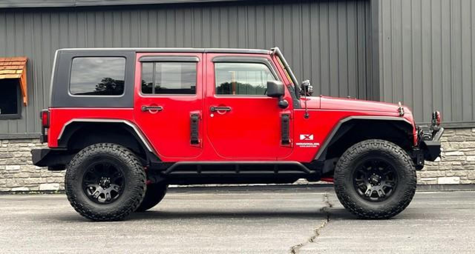 2009 RED JEEP WRANGLER (1J4GA39179L) with an V6,3.8L(231 CID),OHV engine, MANUAL transmission, located at 14600 Frazho Road, Warren, MI, 48089, (586) 776-3400, 42.485996, -82.974220 - Photo#3