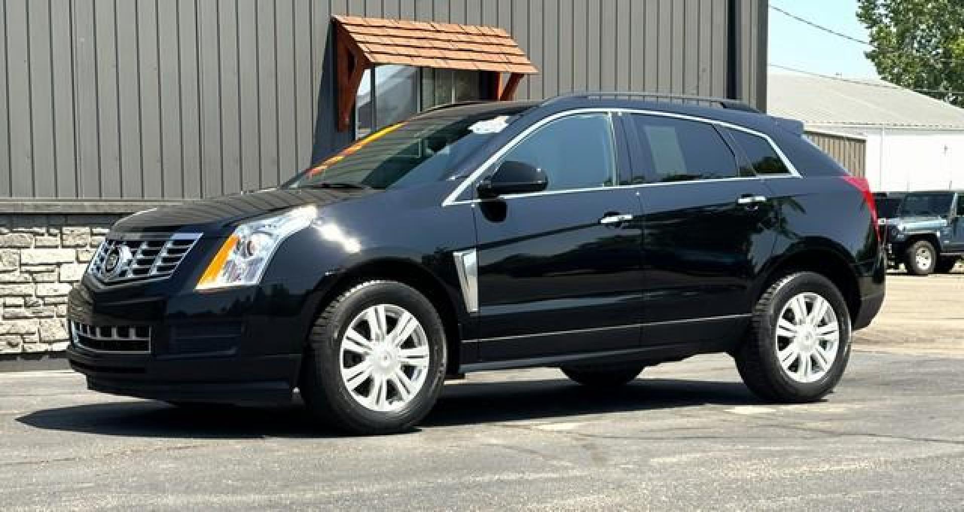 2014 BLACK CADILLAC SRX (3GYFNAE31ES) with an V6,3.6L(217 CID),DOHC engine, AUTOMATIC transmission, located at 14600 Frazho Road, Warren, MI, 48089, (586) 776-3400, 42.485996, -82.974220 - Photo#1